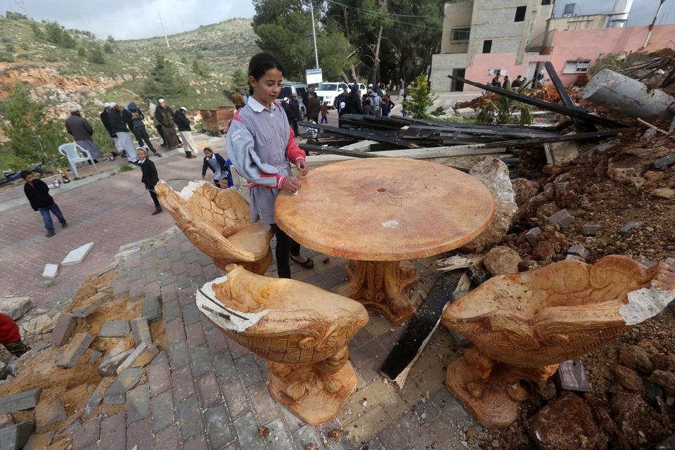 Palestinian children check the destruction in a children's playground, that was built with funding from Belgium, in Zatarah village, south of the West Bank city of Nablus, after it was demolished on April 12, 2016 by Israeli authorities who said it was built in Area C, a closed military zone where Israel exercises full control. Israel often demolishes buildings constructed without the required Israeli permits in Area C of the West Bank, which is under full Israeli control. (AFP)