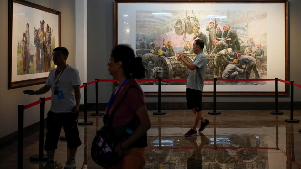 People looking at paintings created by North Korean artists in China-North Korea Cultural Centre in Dandong, China. September 9, 2017.