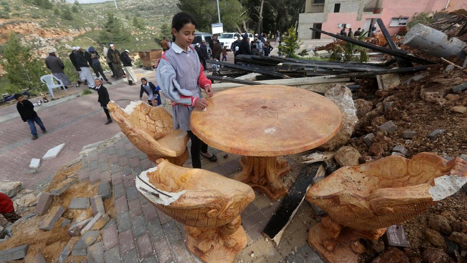 Palestinian children check the destruction in a children's playground, that was built with funding from Belgium, in Zatarah village, south of the West Bank city of Nablus, after it was demolished on April 12, 2016 by Israeli authorities who said it was built in Area C, a closed military zone where Israel exercises full control. Israel often demolishes buildings constructed without the required Israeli permits in Area C of the West Bank, which is under full Israeli control. (AFP)