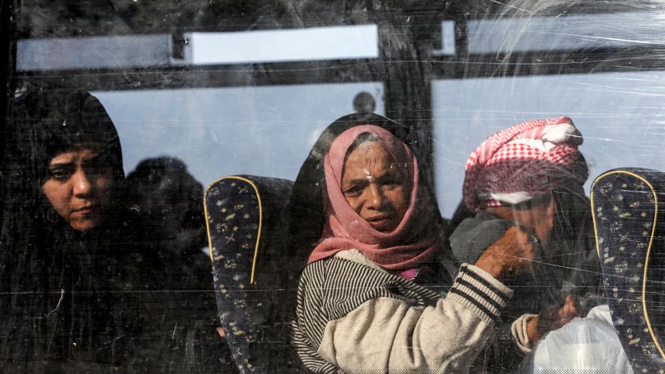 Palestinians ride in a bus in Khan Younis in the southern Gaza strip prior to their departure for the Rafah border crossing with Egypt