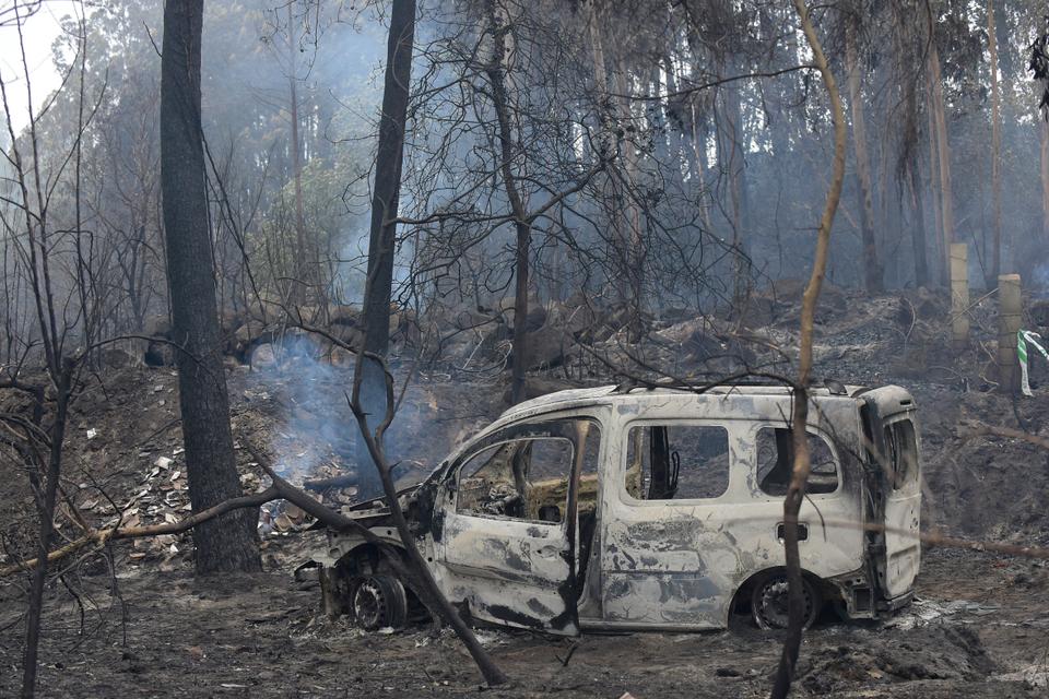 The wreckage of a burned van where two people died trapped by flames is pictured in Chandebrito, near the town of Nigran, northwestern Spain, on October 16, 2017.