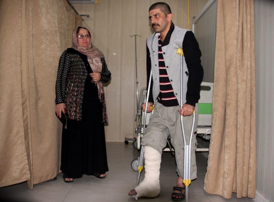 An earthquake victim is helped at Sulaimaniyah Hospital on November 12, 2017, in Sulaimaniyah, Iraq.